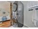 Convenient laundry room featuring a modern stacked washer and dryer at 9443 Palisade Ct, Highlands Ranch, CO 80130