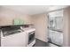 Convenient laundry room with modern, front-loading washer and dryer set at 9443 Palisade Ct, Highlands Ranch, CO 80130