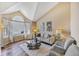 Inviting living room features high ceilings, a neutral color palette, and abundant natural light at 9443 Palisade Ct, Highlands Ranch, CO 80130