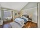 Tranquil main bedroom with hardwood floors, a cozy bed, and ample natural light at 9443 Palisade Ct, Highlands Ranch, CO 80130