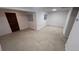 The Basement features wall to wall carpeting, light walls, window and bi-fold door access at 14282 E Radcliff Cir, Aurora, CO 80015