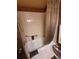 Bathroom with shower-tub combo, toilet, and a towel basket on the wall at 14282 E Radcliff Cir, Aurora, CO 80015