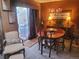 Well-lit dining room with a classic chandelier, wood table, and a sliding glass door to the patio at 14282 E Radcliff Cir, Aurora, CO 80015