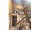 View of the carpeted staircase leading to the second floor, complemented by a wooden railing and earth tone walls at 14282 E Radcliff Cir, Aurora, CO 80015