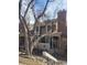 Exterior view of a home with brick accents, large trees, and a neatly landscaped front yard at 14282 E Radcliff Cir, Aurora, CO 80015