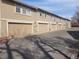 Row of garages with neutral siding and paved driveway, offering ample parking at 14282 E Radcliff Cir, Aurora, CO 80015