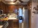 A view of the kitchen including stainless steel refrigerator and brown cabinets at 14282 E Radcliff Cir, Aurora, CO 80015