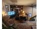 Inviting living room featuring a built-in bookcase and comfortable seating area at 14282 E Radcliff Cir, Aurora, CO 80015