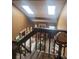 Cozy living room with fireplace, skylights, and a view from the stairway at 14282 E Radcliff Cir, Aurora, CO 80015
