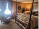 Bedroom with a four-poster bed, sitting area, and a bright window at 14282 E Radcliff Cir, Aurora, CO 80015