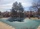 Community pool covered for the off-season, surrounded by trees and residential buildings at 14282 E Radcliff Cir, Aurora, CO 80015