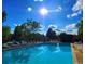 A relaxing pool area with lounge chairs, lush green trees, and beautiful clear blue skies at 14282 E Radcliff Cir, Aurora, CO 80015