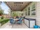 Comfortable covered back patio with string lights, outdoor furniture, and a storage box offers relaxed outdoor living at 4767 S Odessa St, Centennial, CO 80015