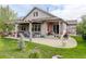Well-maintained backyard with a covered patio, lush greenery, and comfortable seating is ready for relaxation and gatherings at 4767 S Odessa St, Centennial, CO 80015