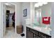 A bathroom with granite countertop vanity, walk in closet, and neutral color scheme at 4767 S Odessa St, Centennial, CO 80015