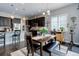 Dining area with dining table and kitchen access with hardwood flooring at 4767 S Odessa St, Centennial, CO 80015