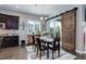 A rustic barn door compliments the dining area near the kitchen, complete with backyard views at 4767 S Odessa St, Centennial, CO 80015