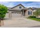Charming exterior view of this lovely home, featuring a lush green lawn, stone accents, and spacious driveway at 4767 S Odessa St, Centennial, CO 80015