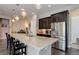 Open kitchen with granite countertops and stainless steel refrigerator at 4767 S Odessa St, Centennial, CO 80015