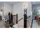 Staircase with decorative balusters and dark wood handrail near the entry way and front dining room at 4767 S Odessa St, Centennial, CO 80015