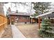 Spacious backyard with walkway, brick home, and a view of the detached garage at 2355 Forest St, Denver, CO 80207