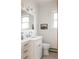 Bathroom with modern vanity, mirror, and a window for natural light at 2355 Forest St, Denver, CO 80207