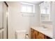 Bathroom features a vanity with a sink, a toilet, and a shower with glass door at 2355 Forest St, Denver, CO 80207