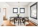 Elegant dining room with dark wood table, modern chairs, natural light from large windows, and hardwood flooring at 2355 Forest St, Denver, CO 80207