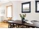 Charming dining area with dark wood table, modern chairs, natural light from a window and hardwood flooring at 2355 Forest St, Denver, CO 80207