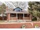 Charming brick home with a cozy front porch and well-maintained landscaping at 2355 Forest St, Denver, CO 80207