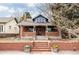 Charming brick home featuring a brick fence, front steps, and a cozy blue-painted dormer at 2355 Forest St, Denver, CO 80207