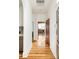 Hallway with hardwood floors leading to a bedroom and kitchen at 2355 Forest St, Denver, CO 80207
