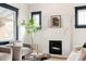 Inviting living room with a cozy fireplace, comfortable seating, and large windows with hardwood floors at 2355 Forest St, Denver, CO 80207