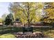 Entrance to W.H. Ferguson Park showcasing lush greenery, play structures, and a charming gazebo at 2355 Forest St, Denver, CO 80207