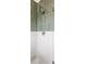 Glass enclosed shower with chrome fixtures and vertically stacked olive green tile at 2355 Forest St, Denver, CO 80207