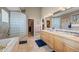 Luxurious bathroom featuring dual vanities, a glass-block shower, and tile flooring at 4749 Old Post Ct, Boulder, CO 80301