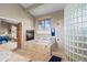 Bathroom with soaking tub, fireplace, and glass block shower at 4749 Old Post Ct, Boulder, CO 80301