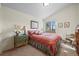 Cozy bedroom with sloped ceiling, floral bedding, and window with natural light at 4749 Old Post Ct, Boulder, CO 80301
