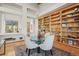 Charming dining area with hardwood floors, decorative rug, adjacent to the living room and large built-in bookcase at 4749 Old Post Ct, Boulder, CO 80301