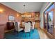 Dining room area with elegant lighting, seating for six, and access to the outside patio at 4749 Old Post Ct, Boulder, CO 80301