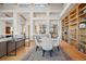 Open floor plan featuring a dining table and large built-in bookshelf off the living room at 4749 Old Post Ct, Boulder, CO 80301