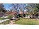 Beautiful front exterior of the home with a well-manicured yard and mature trees at 4749 Old Post Ct, Boulder, CO 80301