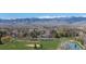 Expansive view of a golf course with lush green fairways, trees, and mountain views at 4749 Old Post Ct, Boulder, CO 80301