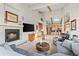 Open-concept living room with fireplace, skylight, and views to the kitchen at 4749 Old Post Ct, Boulder, CO 80301