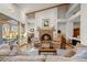 Cozy living room featuring a fireplace, comfortable seating, and natural light streaming in at 4749 Old Post Ct, Boulder, CO 80301
