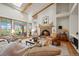 Inviting living room features a fireplace, exposed beams, and view through french doors to exterior patio at 4749 Old Post Ct, Boulder, CO 80301
