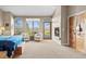 Main bedroom with sitting area, fireplace, and access to a private balcony at 4749 Old Post Ct, Boulder, CO 80301