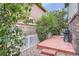 Cozy backyard featuring a small patio with grill, rock landscaping, and a white fence creating a private outdoor space at 5892 W 94Th Pl, Westminster, CO 80031