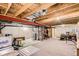 Unfinished basement with exposed beam ceiling, concrete walls, and space for utilities or storage at 5892 W 94Th Pl, Westminster, CO 80031