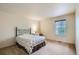 Cozy bedroom with a floral patterned bedspread, a window and neutral carpeting at 5892 W 94Th Pl, Westminster, CO 80031